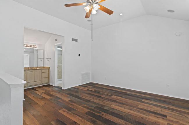 Upstairs bedroom with ensuite bathroom and wood like flooring. | Image 21