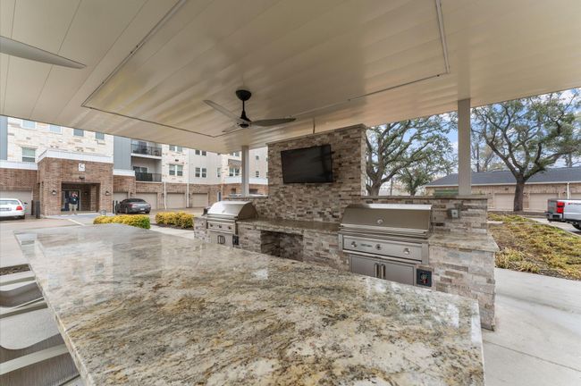 Resort-style outdoor kitchen and grilling station with covered seating, perfect for hosting barbecues and gatherings. | Image 23