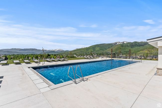 Community pool featuring a patio, fence, and a mountain view | Image 10