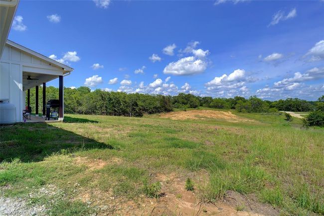 View of yard featuring ceiling fan | Image 33