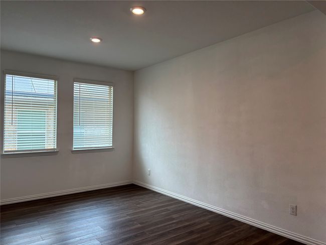 Unfurnished room featuring dark wood-type flooring, baseboards, and recessed lighting | Image 8