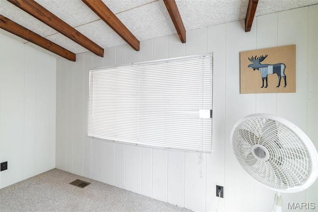 Unfurnished room with visible vents, beamed ceiling, a textured ceiling, and carpet | Image 38