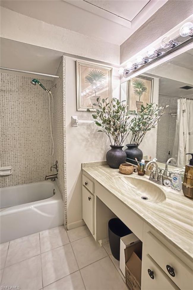 Bathroom with tile patterned flooring, shower / bath combination with curtain, and vanity | Image 27