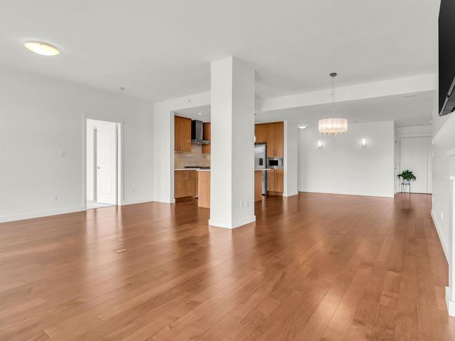 Unfurnished living room featuring a chandelier and light wood-type flooring | Image 20