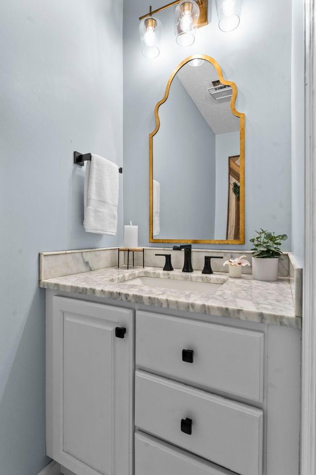 Easy access to a stylish ½ bath with tiled flooring adds functionality. | Image 12