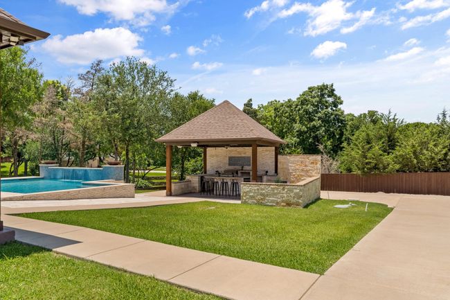 View of yard with a gazebo, an outdoor pool, and a patio | Image 36