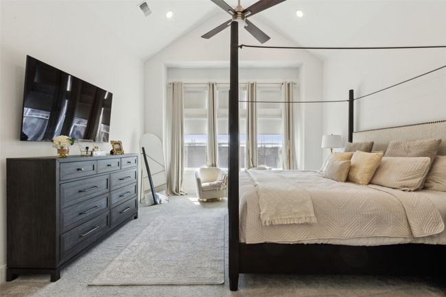 Bedroom with light colored carpet, vaulted ceiling, recessed lighting, and a ceiling fan | Image 16