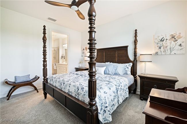 Carpeted bedroom with ensuite bathroom and a ceiling fan | Image 17