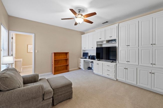 Living area featuring a ceiling fan, baseboards, visible vents, built in study area, and light​​‌​​​​‌​​‌‌​‌‌​​​‌‌​​‌‌​‌​​​​​‌ carpet | Image 27