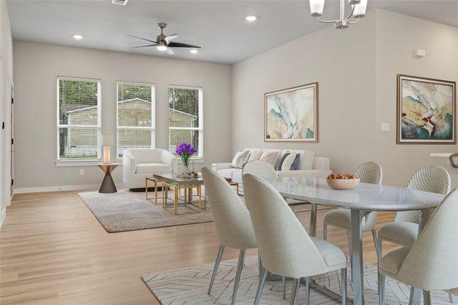A stunning dining and living area bathed in natural light—perfect for making it your new home! (virtually staged) | Image 6
