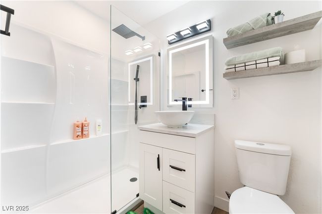 Full bathroom featuring toilet, vanity, and walk in shower | Image 21