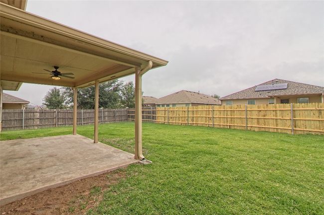 Fenced backyard featuring a patio and ceiling fan | Image 31