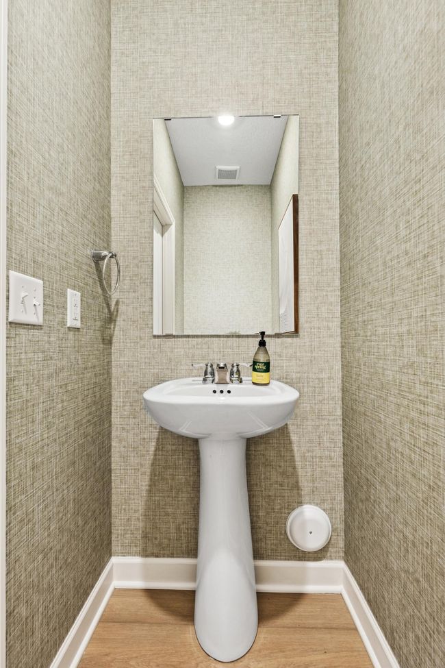 (Photo of model home, features will vary). Situated directly off the kitchen, this powder room optimizes the first-floor main living area for residents and guests alike. | Image 9