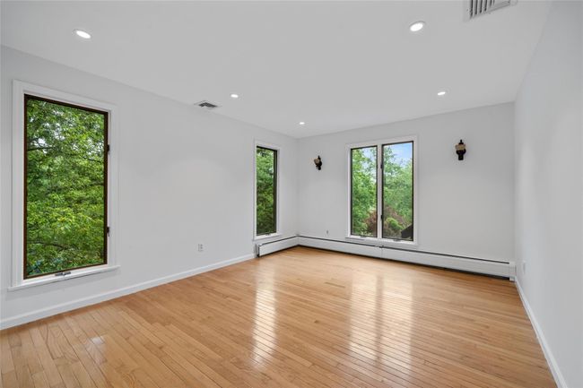 Spare room with hardwood / wood-style floors, a baseboard radiator, and recessed lighting | Image 7