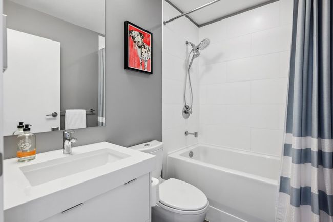Bathroom with toilet, shower / tub combo with curtain, and vanity | Image 30