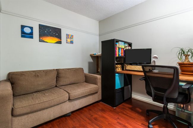 Home office featuring dark wood-style flooring and a textured ceiling | Image 20