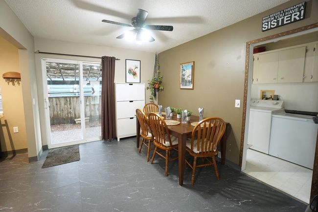 Dining room with independent washer and dryer, ceiling fan, and a textured ceiling | Image 9