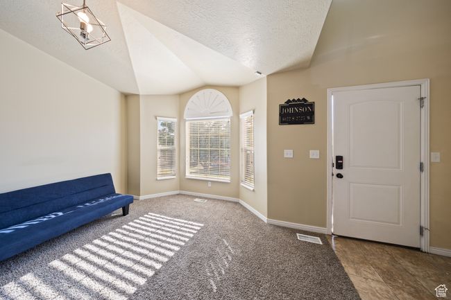 Foyer with lofted ceiling and a textured ceiling | Image 5