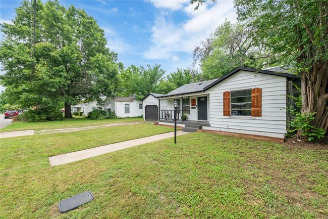 Ranch-style house featuring covered porch, a front yard, and driveway | Image 23