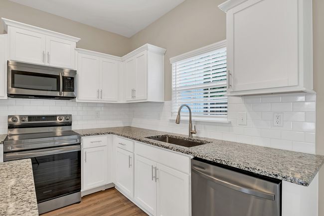 Custom tile backsplash + stainless steel appliances | Image 11