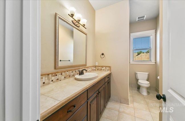 Bathroom featuring vanity, tile patterned flooring, and tasteful backsplash | Image 25