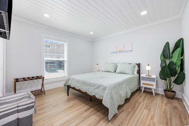 Bedroom with ornamental molding, light wood-style floors, recessed lighting, and baseboards | Image 19