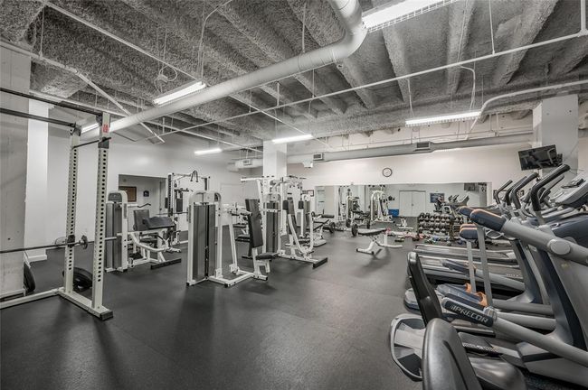 The large Fitness Center at Commerce Towers offers a variety of equipment. It is located on the 8th floor, and there are restrooms attached to this room! In addition to working out here, remember there are numerous gyms in Downtown & you are a few blocks away from Buffalo Bayou Hike and Bike trails as well! | Image 29
