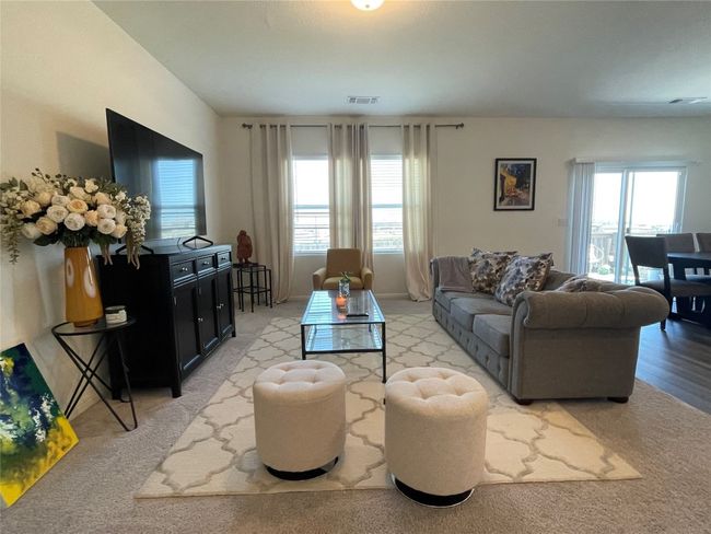 Open to the kitchen, this is a great place to watch your favorite show while preparing a meal. | Image 8