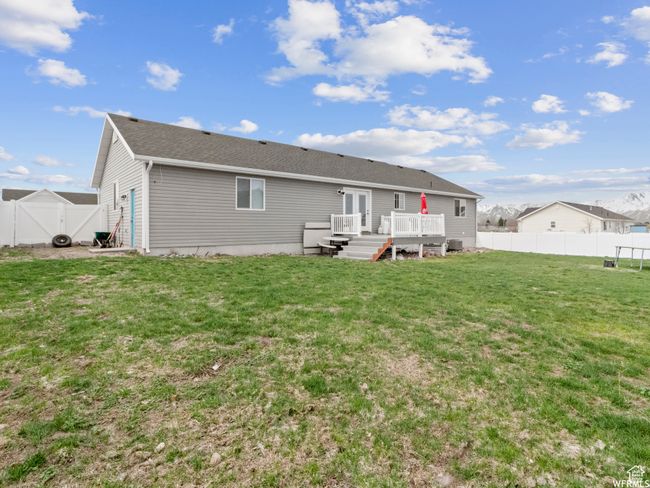 Rear view of house with a deck and a gate | Image 21