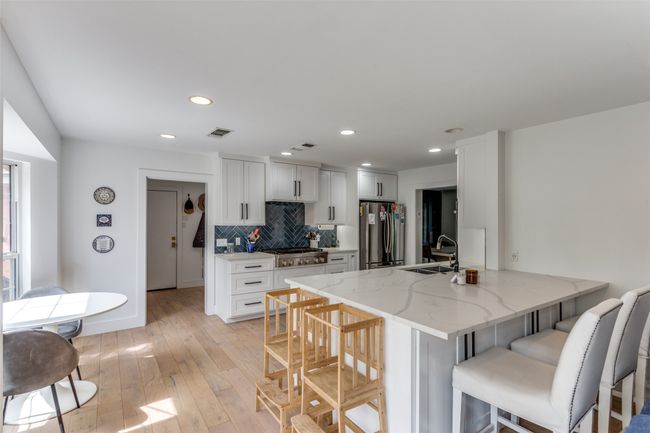 Kitchen area with mudroom beyond. | Image 10