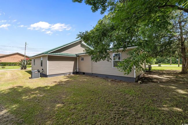 View of property exterior featuring crawl space and a yard | Image 10