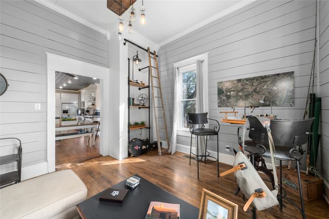 Office space featuring crown molding, wood walls, and wood finished floors | Image 11