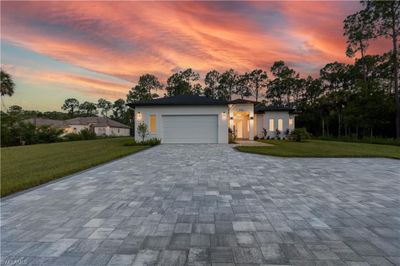 View of front of house with a garage and a lawn | Image 2