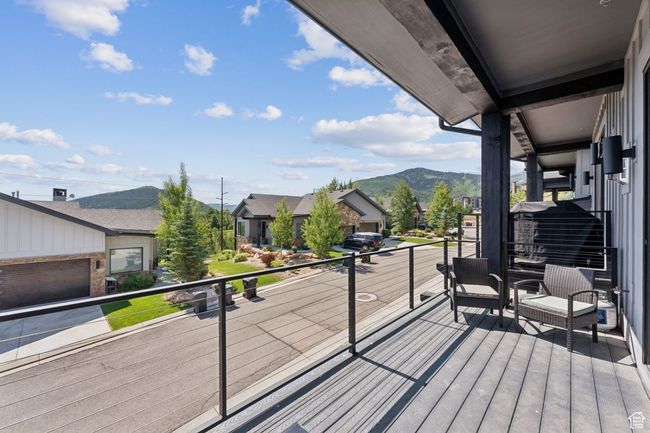 Wooden deck with a mountain view and a residential view | Image 4