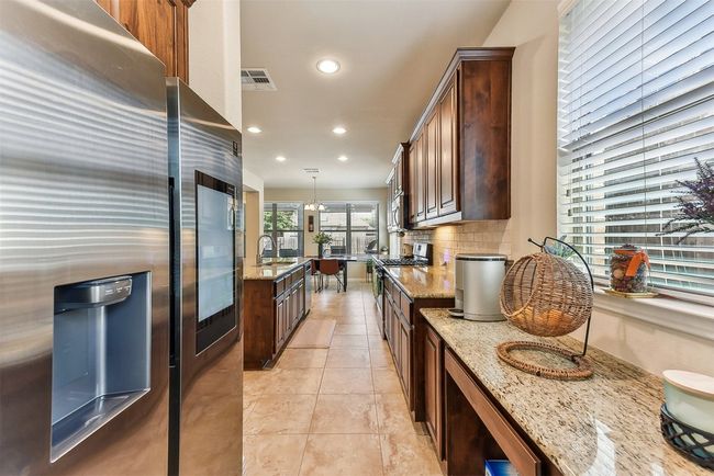 The open-concept layout keeps the kitchen connected to the living and dining areas, so you’re never far from the conversation | Image 12