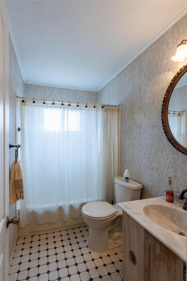 Bathroom with shower / bath combination with curtain, toilet, ornamental molding, vanity, and tile patterned floors | Image 18