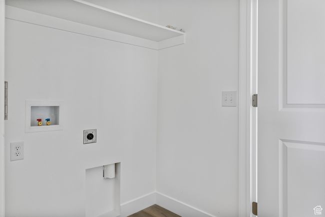Laundry room featuring hookup for an electric dryer, washer hookup, baseboards, dark wood-type flooring, and laundry area | Image 15