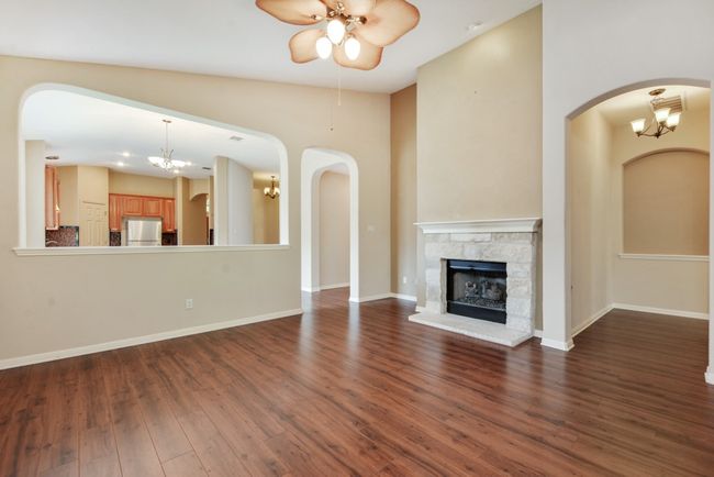 The main living area centers around a cozy fireplace, with effortless flow into the kitchen and dining space—perfect for gathering with friends and family. | Image 20