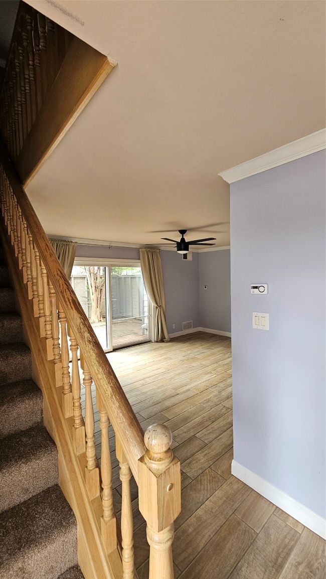 Stairs with wood finished floors and ceiling fan | Image 29