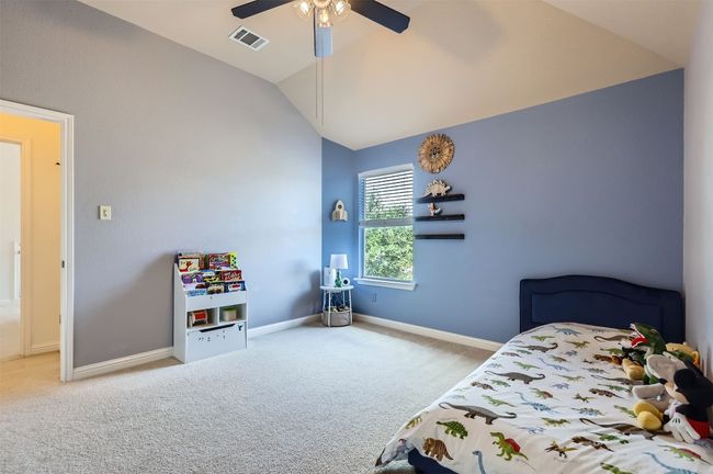 Comfortable secondary bedroom with angled ceiling. | Image 21