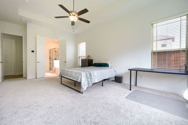 Bedroom with visible vents, carpet flooring, baseboards, and ceiling fan | Image 17