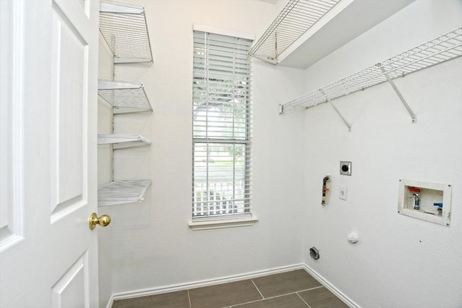 Laundry room featuring hookup for a washing machine, electric dryer hookup, and hookup for a gas dryer | Image 8