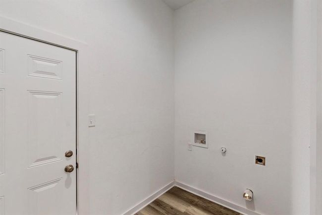 Laundry room featuring hookup for an electric dryer, hookup for a washing machine, gas dryer hookup, and hardwood / wood-style flooring | Image 30