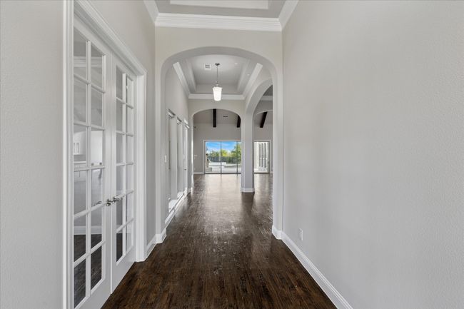 Entrance into the home with beautiful wood floors and arch doorways | Image 6