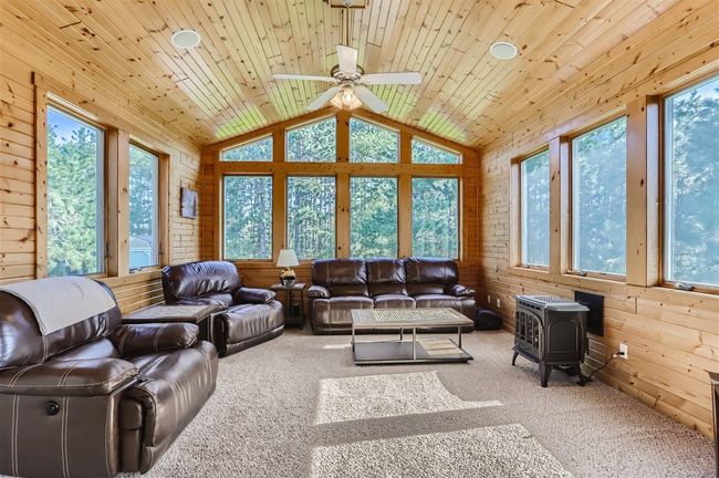 Look at this 4 Season Sun Room! It's spacious, beautiful and cozy all at the same time. An absolute favorite room of the homeowners. This room also looks out into the beautiful, fully-irrigated, tree-lined backyard. | Image 11