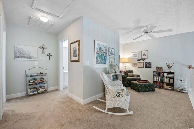 Living area featuring a textured ceiling, carpet flooring, and ceiling fan | Image 28