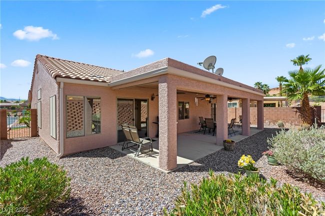 Back of house featuring ceiling fan, stucco siding, and a patio | Image 48