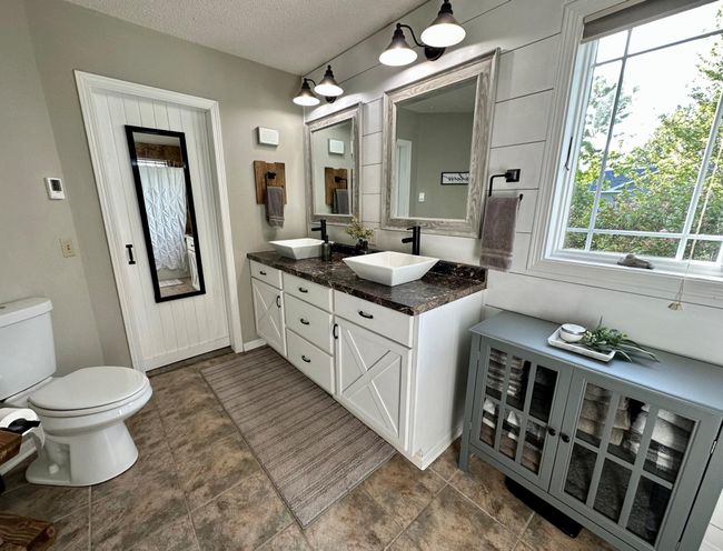 Main level bath updated modern barnyard style with walk-thru to master bedroom | Image 12