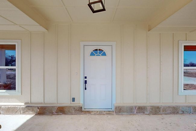 Entrance to property featuring board and batten siding | Image 4