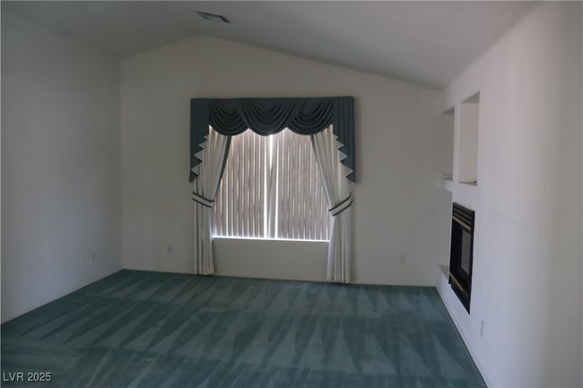Unfurnished living room with carpet floors and lofted ceiling | Image 42